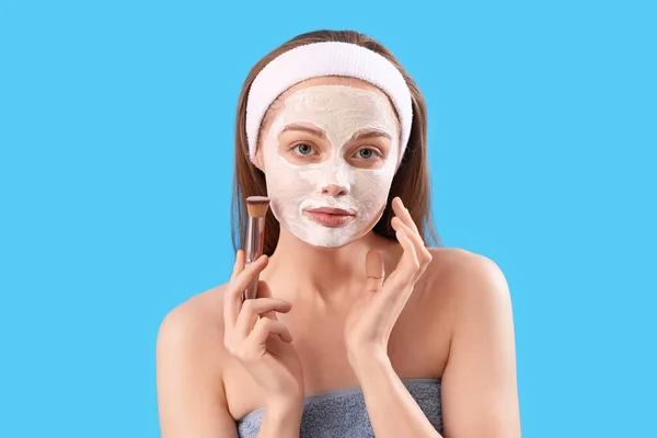 Young Woman Applied Turmeric Mask Brush Blue Background Closeup — Stock Photo, Image