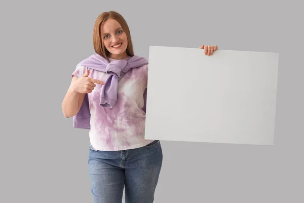 Beautiful Woman Pointing Big Blank Poster Grey Background — Stock Photo, Image