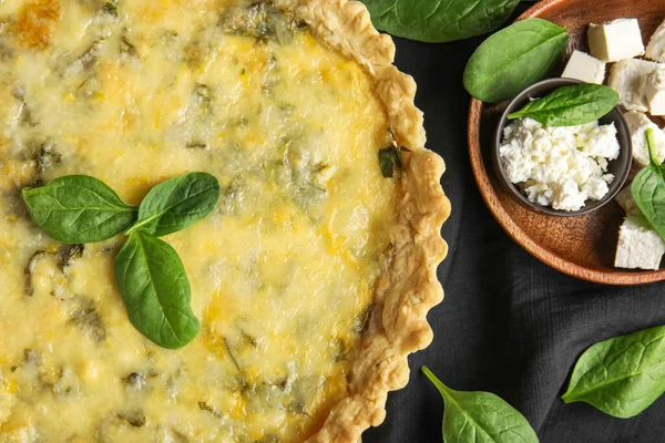 stock image Delicious quiche, feta and cottage cheese on black napkin, closeup