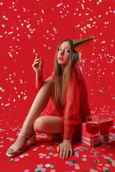Drunk Young Woman Burning Candle Celebrating Birthday Red Background — Stock Photo, Image