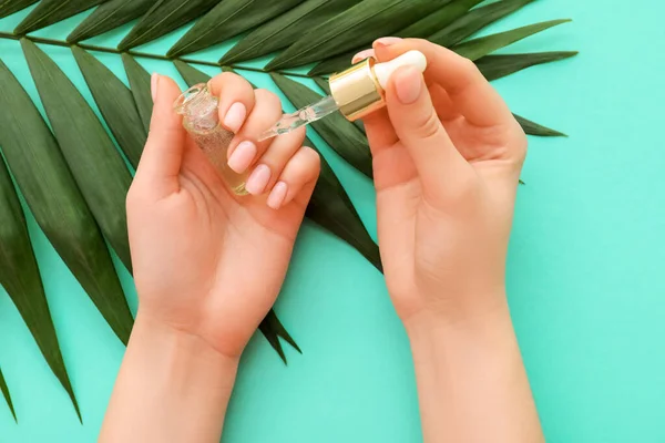 Female Hands Bottle Cuticle Oil Palm Leaf Color Background Closeup — Stock Photo, Image