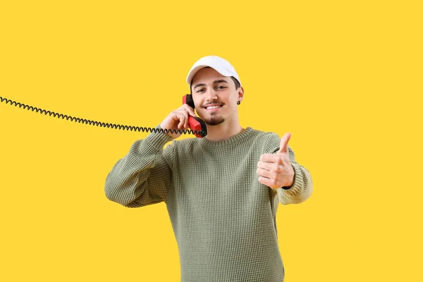 Cool Young Man Phone Receiver Showing Thumb Gesture Yellow Background — Stock Photo, Image