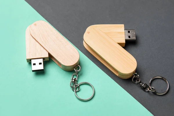 Wooden USB flash drives on turquoise and black background
