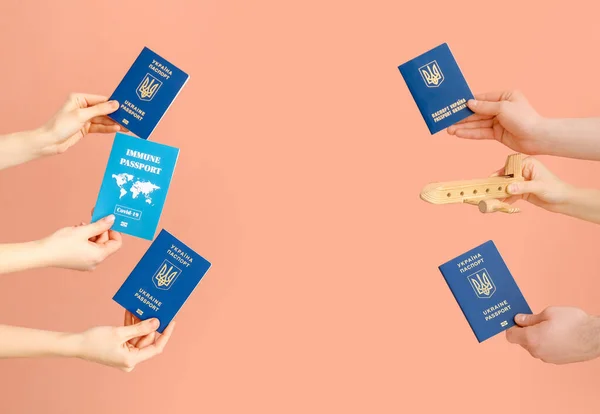Frame Made Female Hands Ukrainian Immune Passports Wooden Airplane Pink — Stock Photo, Image