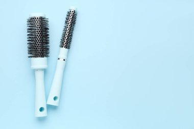 Mavi arka planda yuvarlak saç fırçaları