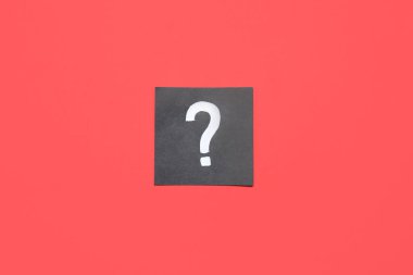 Kırmızı arkaplanda soru işareti olan kağıt