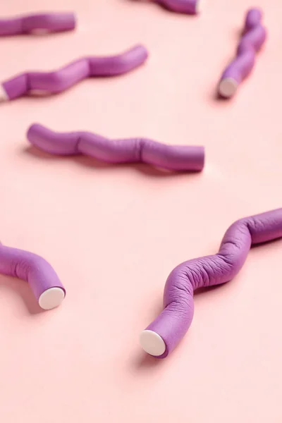 stock image Hair curlers on pink background, closeup