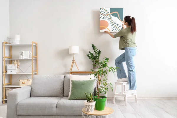 Young Woman Hanging Picture Wall Living Room — Stock Photo, Image