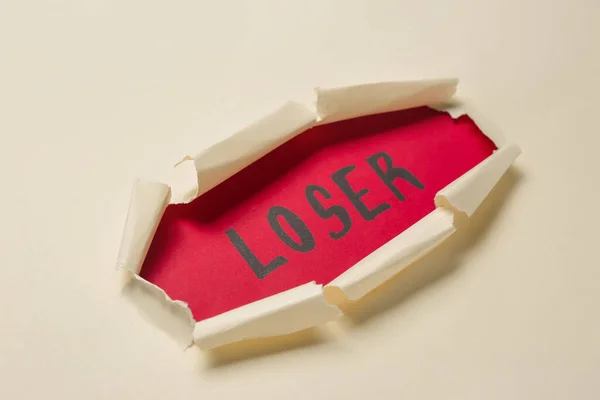 Слово Loser Видно Через Отверстие Белой Бумаге Крупным Планом — стоковое фото