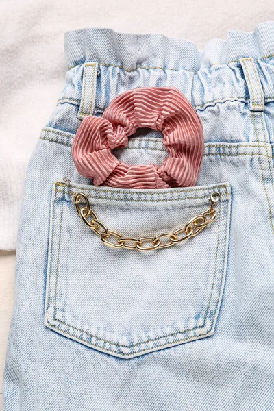 stock image Silk scrunchy with bracelet on jeans, closeup