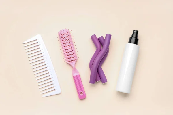Hair Brushes Curlers Spray Bottle Beige Background — Stock Photo, Image