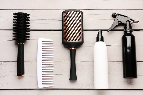 Hair Brushes Spray Bottles Light Wooden Background — Stock Photo, Image