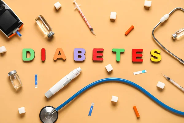 stock image Word DIABETES with medical supplies on orange background