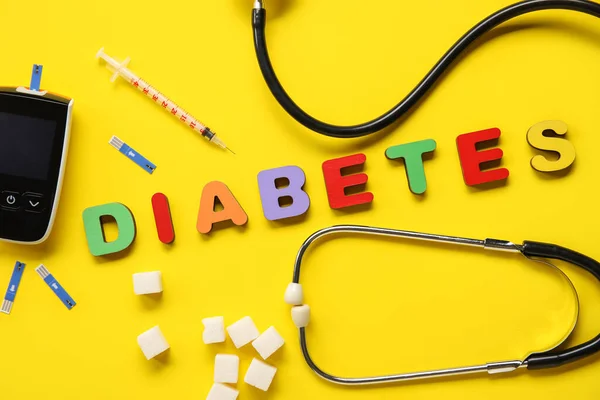 stock image Word DIABETES with sugar, glucometer and syringe on yellow background