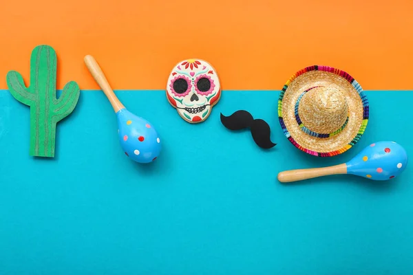 stock image Mexican maracas with cookie, sombrero hat, paper mustache and cactus on color background