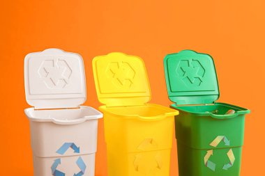 Sarı arka planda çöp kutuları var. Geri dönüşüm kavramı
