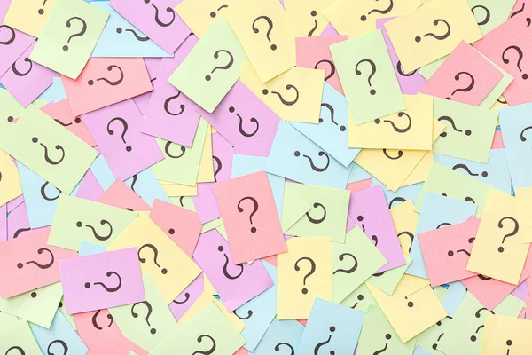 Colorful papers with question marks as background