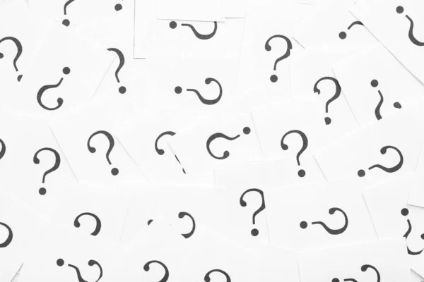 White papers with question marks as background