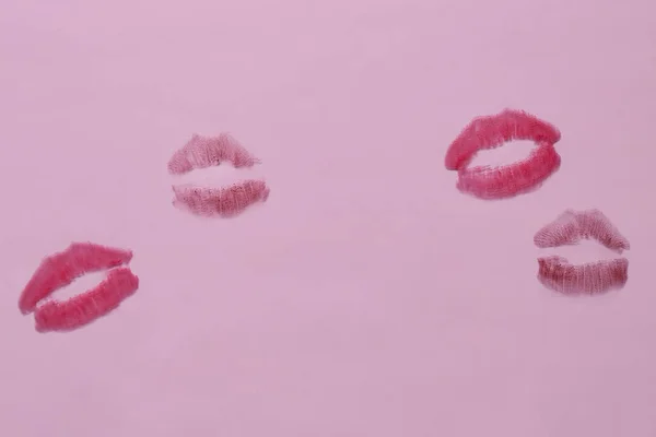 Lipstick kiss marks on lilac background