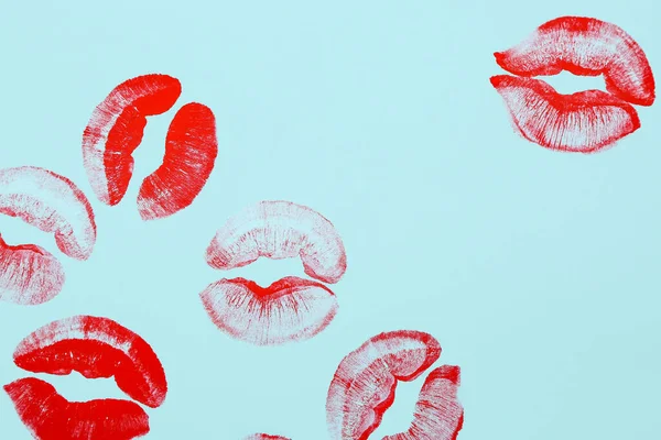 Red lipstick kiss marks on blue background