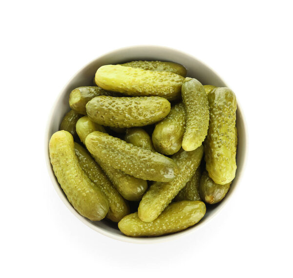 Bowl with tasty fermented cucumbers on white background