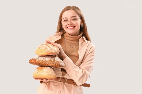 Young Woman Loaves Fresh Bread Light Background — Zdjęcie stockowe