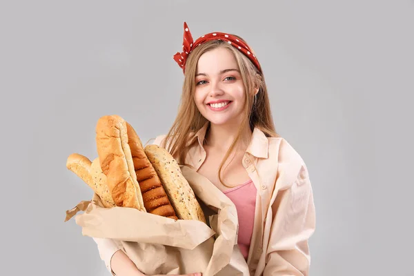 Young Woman Fresh Baguettes Grey Background — Zdjęcie stockowe