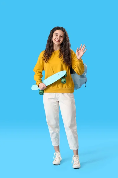 Teenage Girl Skateboard Backpack Waving Hand Blue Background — Stock Photo, Image