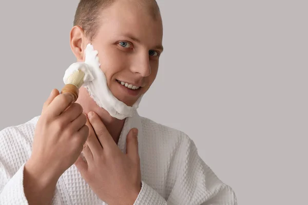 Young Man Applying Shaving Foam Face Light Background — Stock Photo, Image