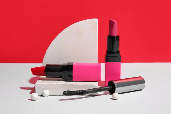 Lipsticks Mascara Podium Table Red Wall — Stock Photo, Image