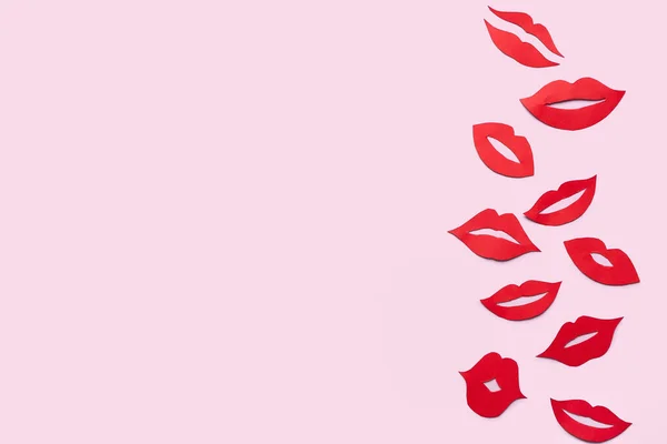 Red paper lips on pink background