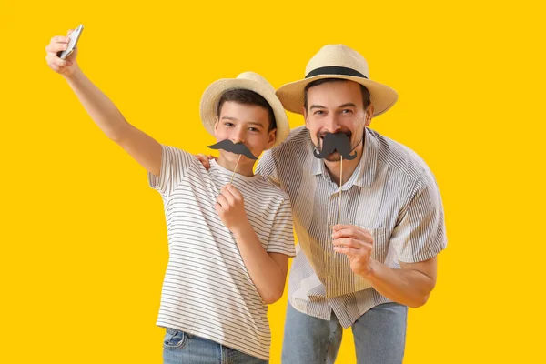 Portrait Father His Little Son Paper Mustache Taking Selfie Yellow — Stock Photo, Image
