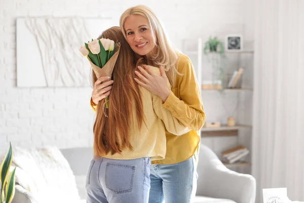 Mature Woman Tulips Hugging Her Daughter Home Mother Day Celebration — Stock Photo, Image