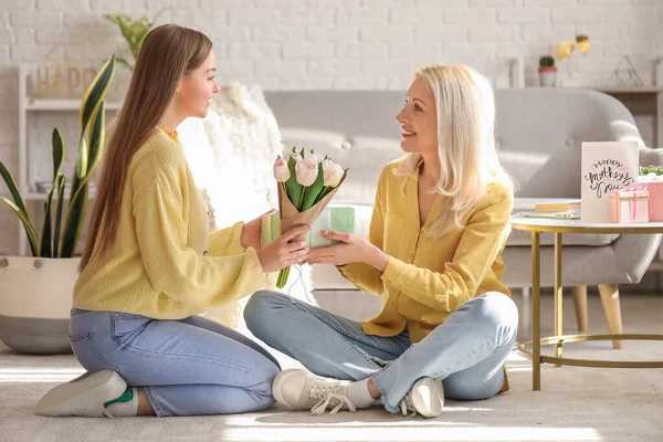 Young Woman Greeting Her Mother Tulips Gift Home — Stock Photo, Image