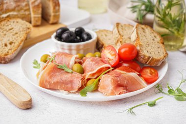 Lezzetli jamon dilimli tabak ve hafif arka planda ekmek.