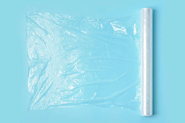 Roll of stretch wrap on blue background