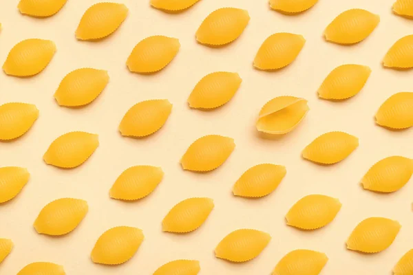 stock image Raw conchiglie pasta on yellow background