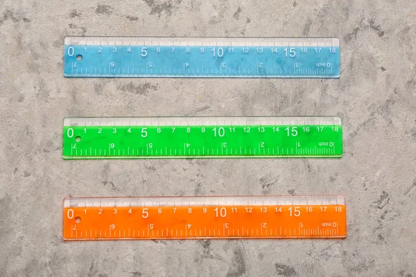 Colorful Plastic Rulers Grey Grunge Background — Stock Photo, Image