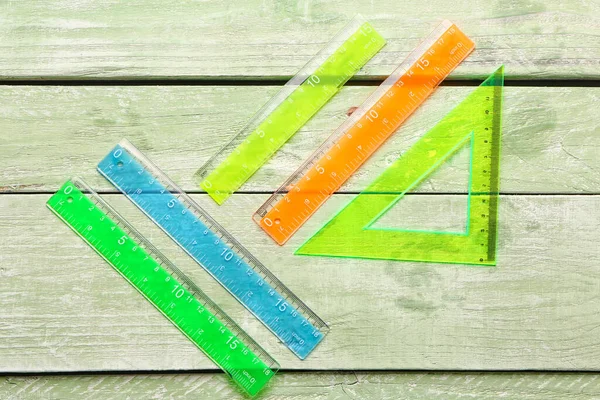 Règles Plastique Droites Triangulaires Colorées Sur Fond Bois Vert — Photo
