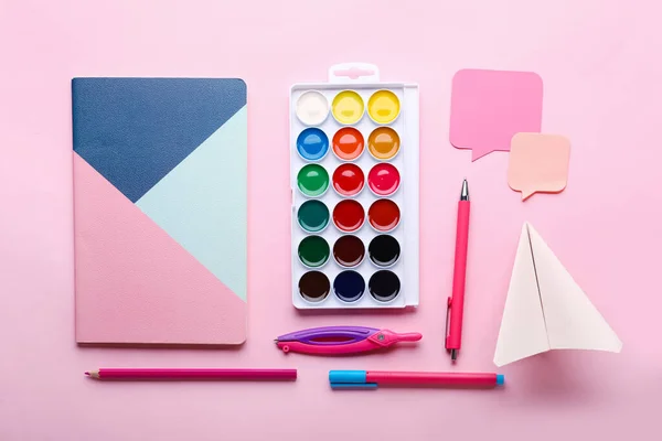 stock image Composition with stationery supplies and paper plane on pink background