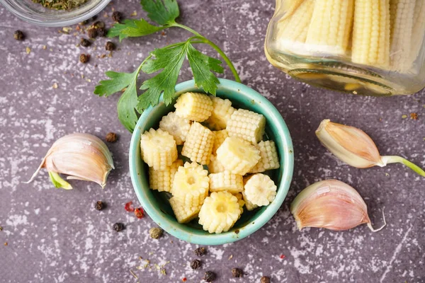 stock image Bowl with cut canned baby corn cobs on grey grunge background