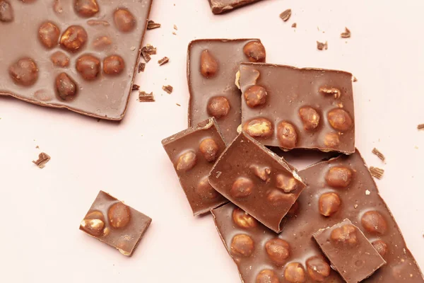 Sweet Tasty Chocolate Nuts Light Pink Background — Stock Photo, Image