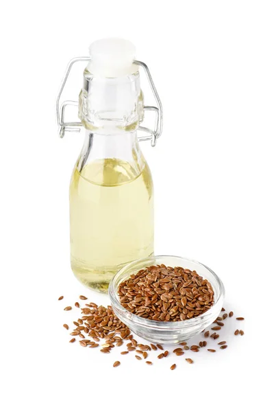 stock image Bottle with flax oil and bowl of seeds on white background