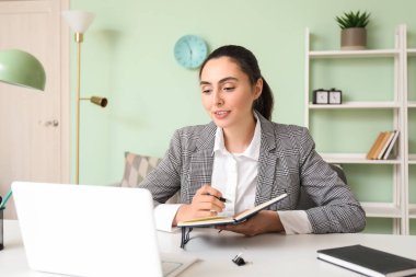 Female tutor giving online lesson at home