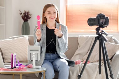 Female blogger with vibrator conducting sex education online at home