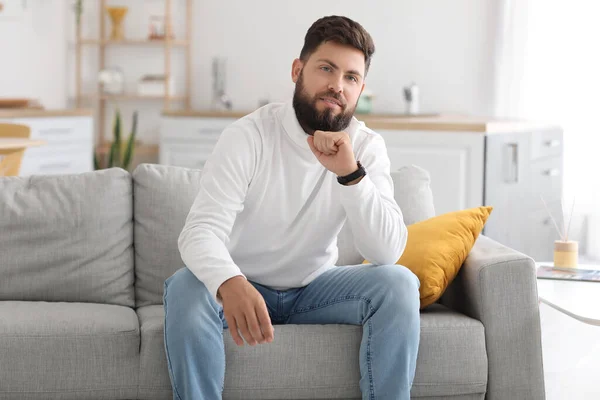 Thoughtful Young Bearded Man Sitting Sofa Kitchen — Stok fotoğraf