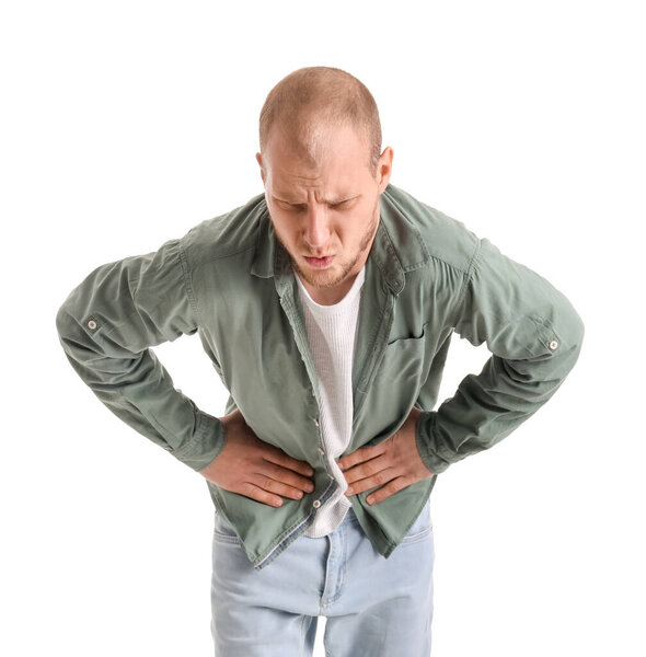 Young man with appendicitis on white background