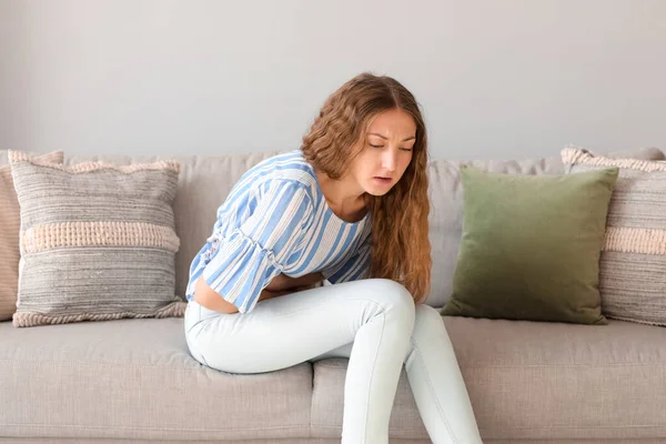 Young Woman Appendicitis Sitting Sofa Home — Stock Photo, Image