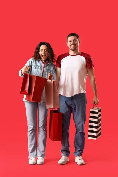 Young Couple Shopping Bags Red Background — Stock Photo, Image