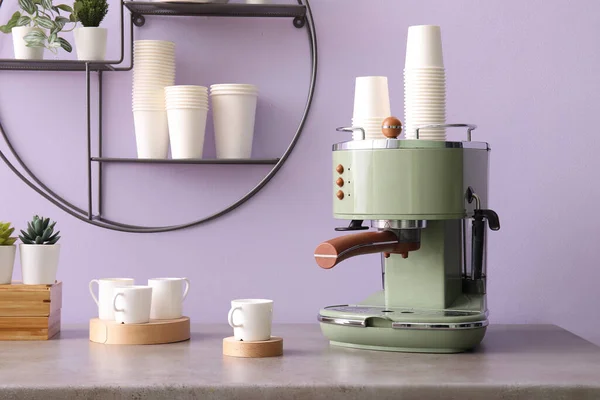 Modern Coffee Machine Takeaway Cups Houseplants Table Lilac Wall — Stock Photo, Image